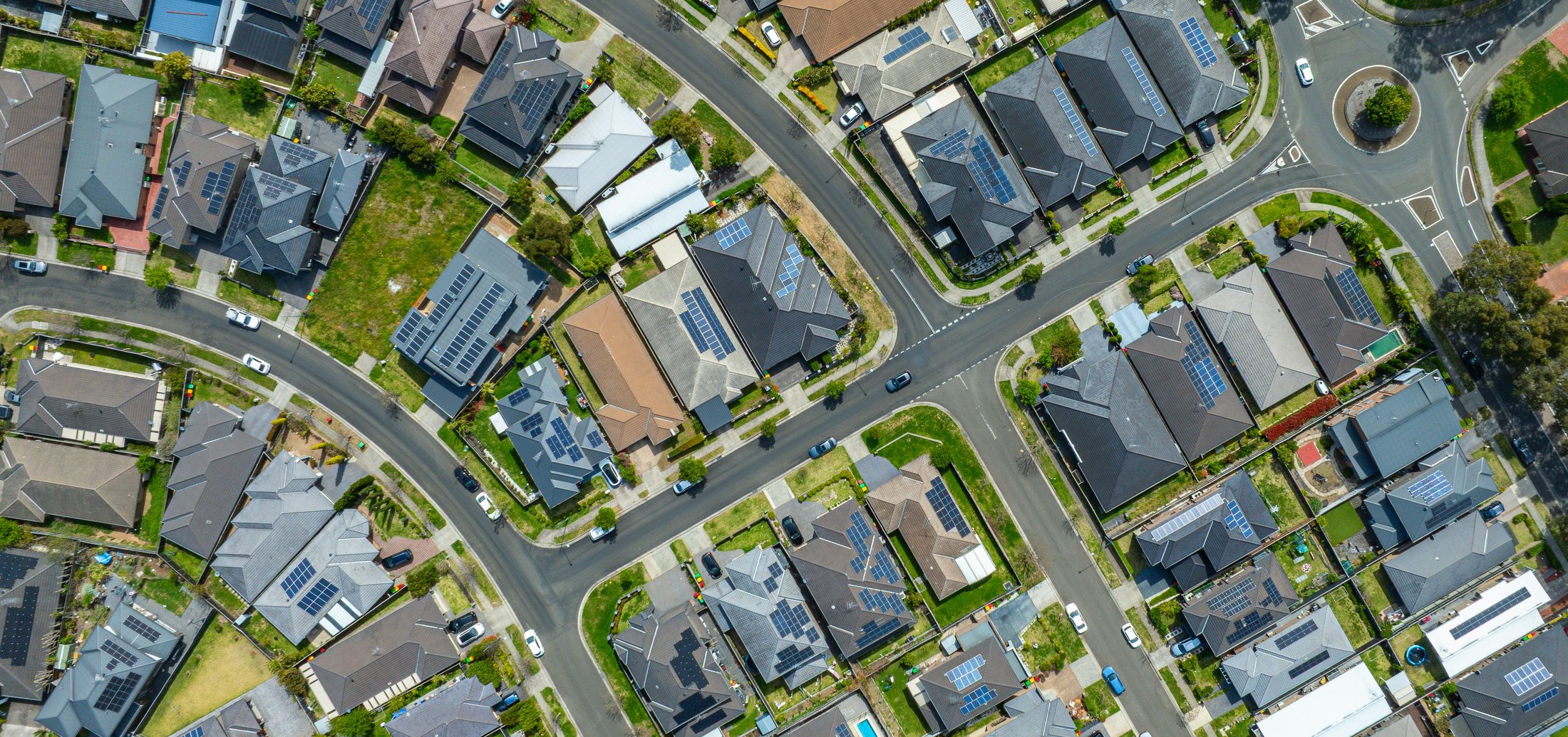 Aerial view of a suburban neighbourhood with rooftop solar panels