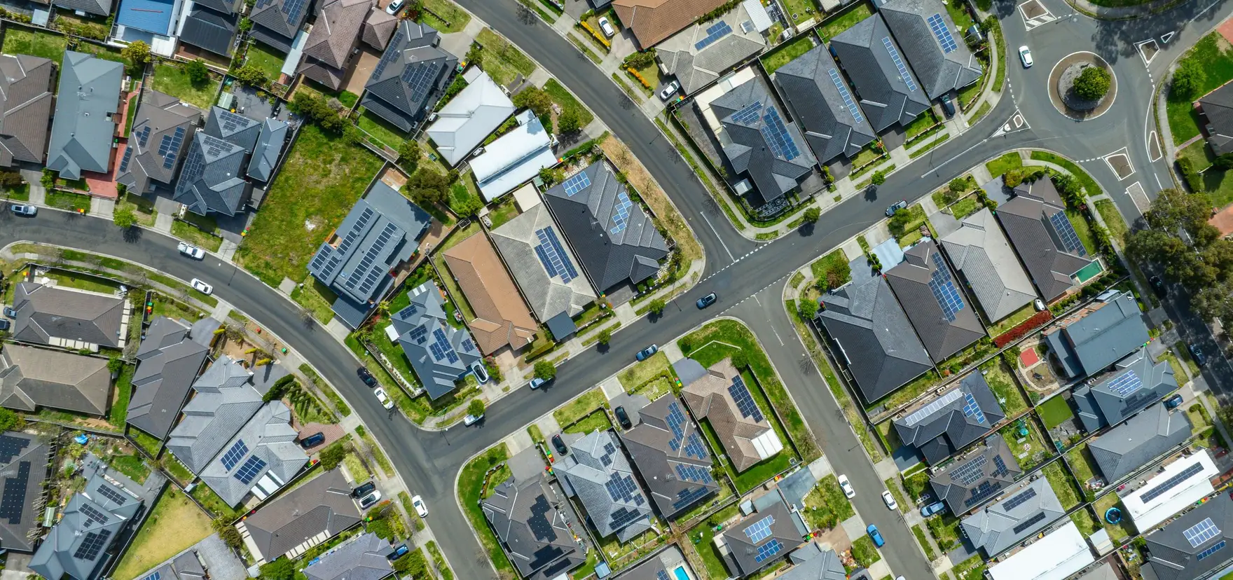 Aerial view of a suburban neighbourhood with rooftop solar panels