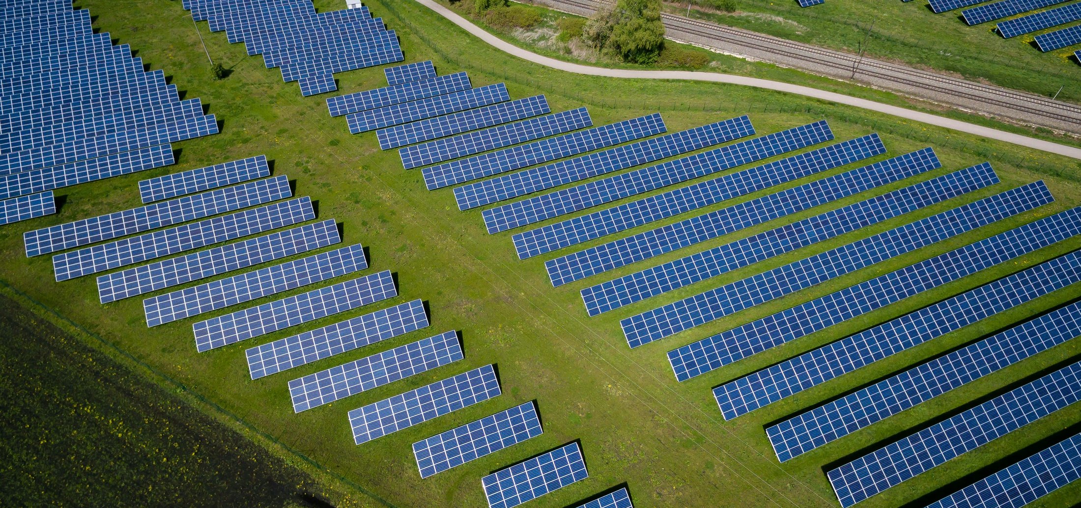 Aerial view of rows of solar panels in a solar farm