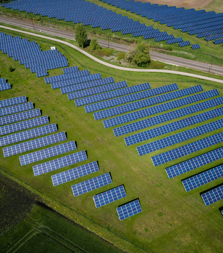 Aerial view of rows of solar panels in a solar farm